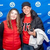 Two young women posing in front of GV Alumni backdrop